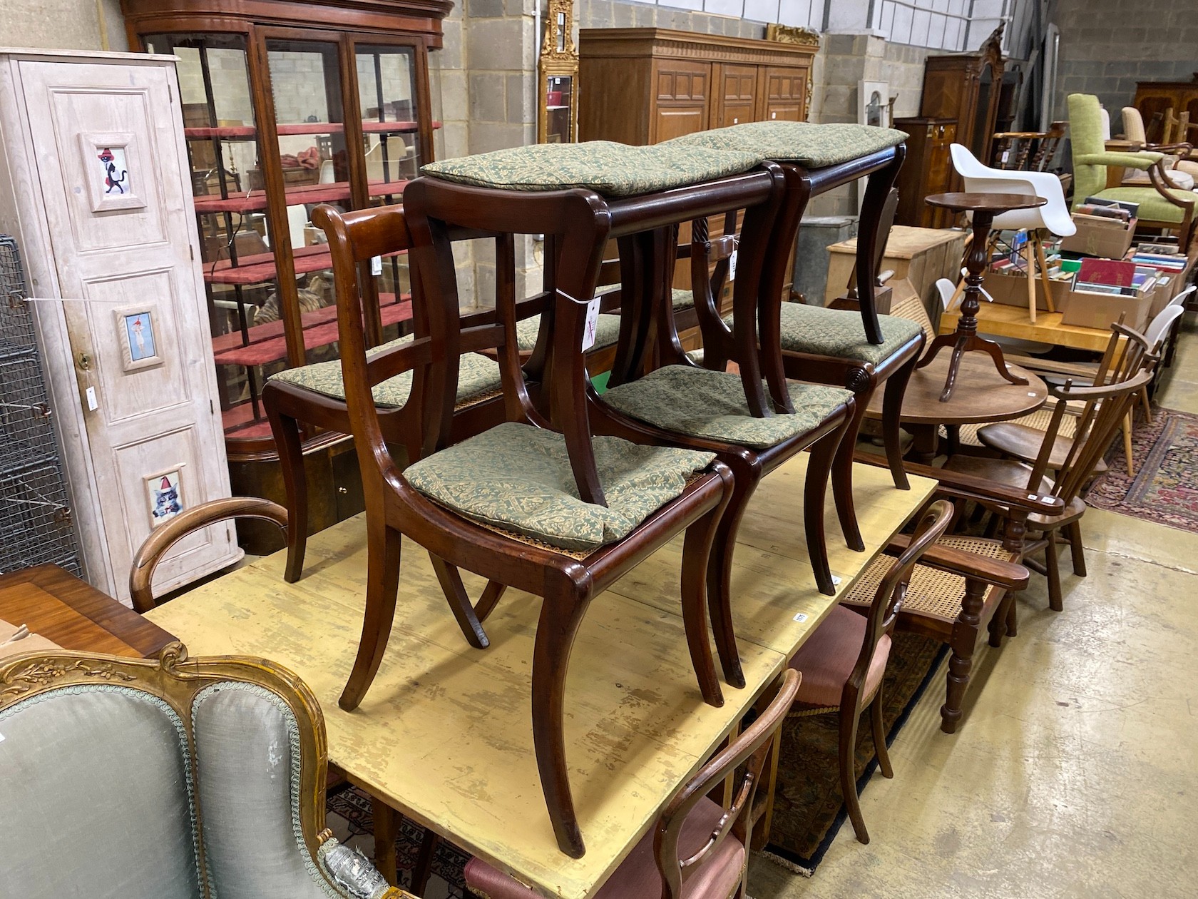 Six Regency mahogany cane and drop in seat dining chairs (four plus two) together with a pair of similar stools